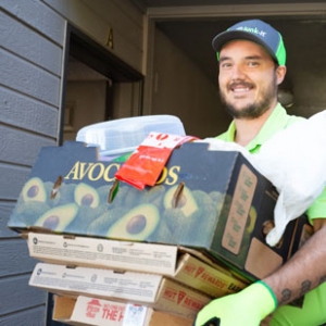 Junk-IT crew member hauling off cardboard from a home